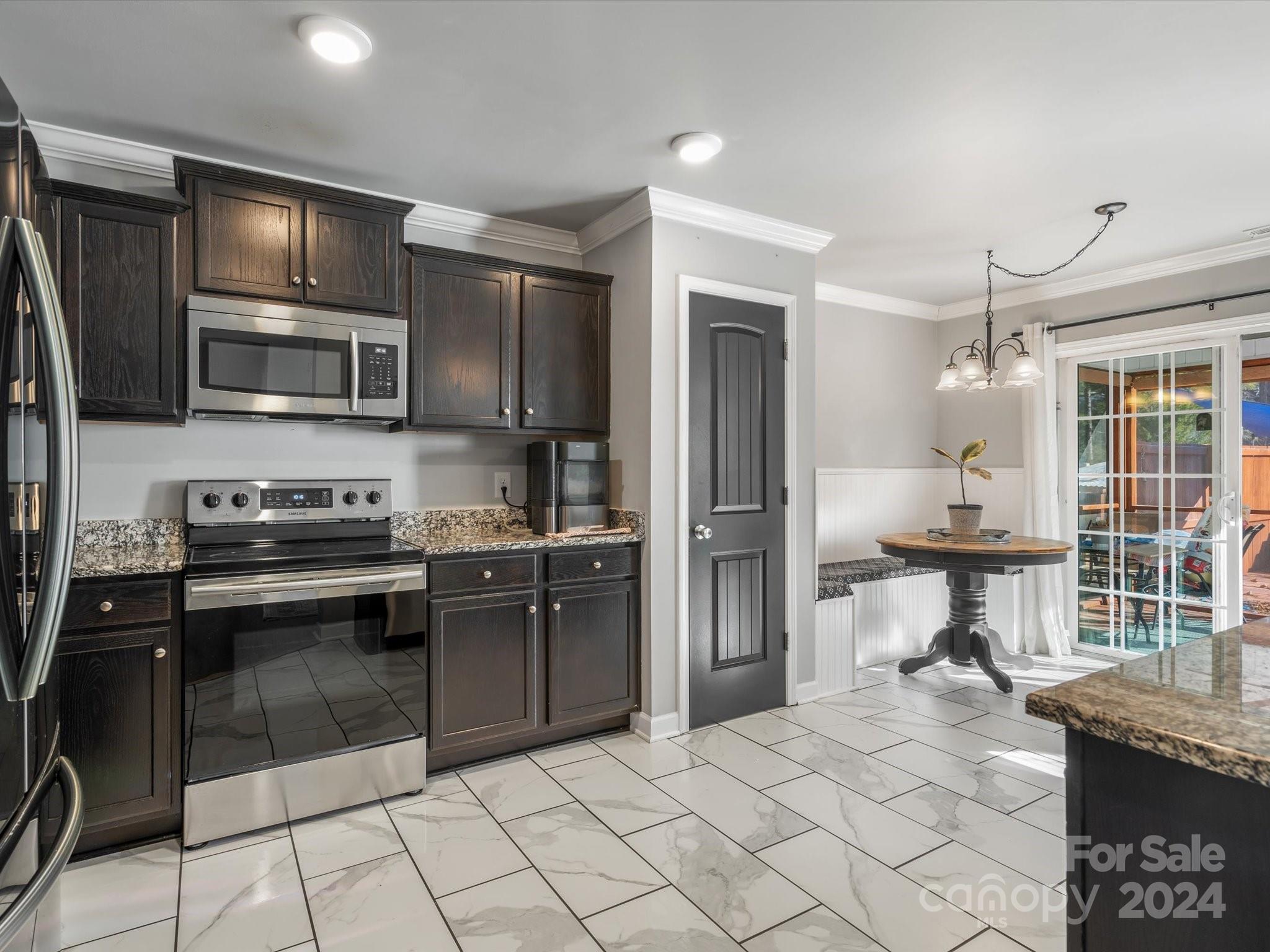 1128 State Rd S-46-817 York, SC 29745 - Photo 5 of 22 a kitchen with granite countertop a stove cabinets and stainless steel appliances
