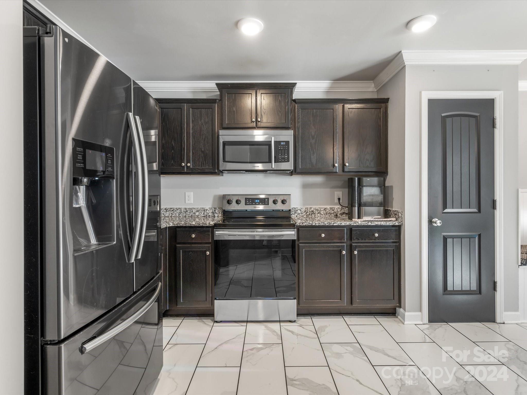 1128 State Rd S-46-817 York, SC 29745 - Photo 6 of 22 a kitchen with granite countertop a refrigerator and a sink
