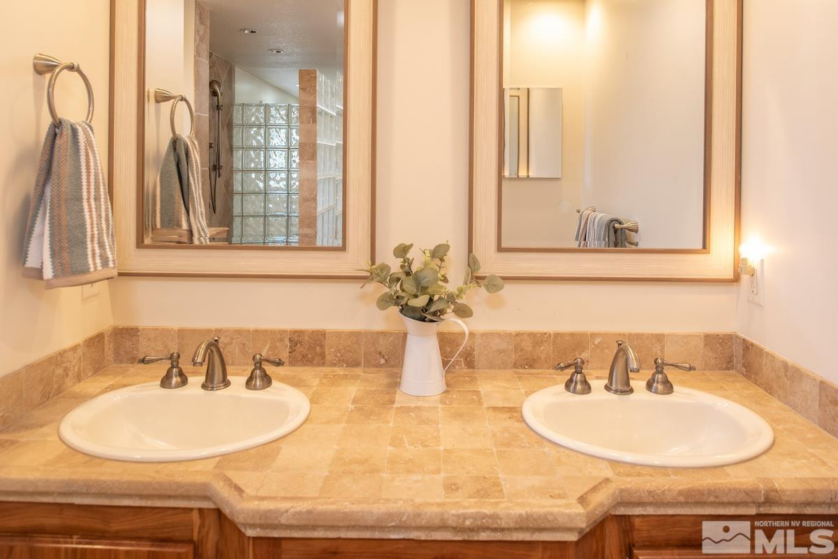 3900 Warren Way Reno, NV 89509 - Photo 19 of 29 a bathroom with a sink and a mirror