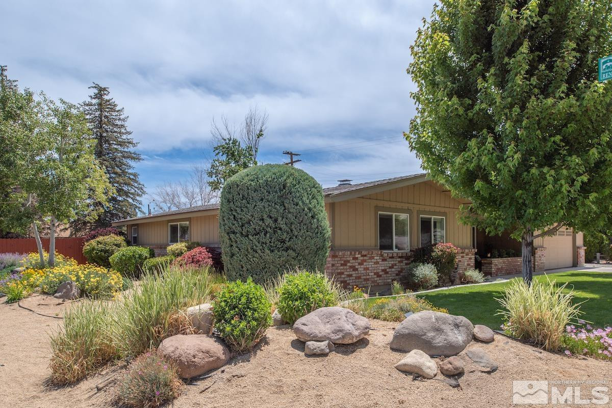 3900 Warren Way Reno, NV 89509 - Photo 5 of 29 a front view of a house with a yard and a garden