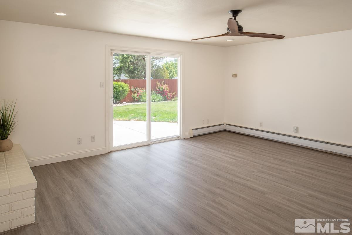 3900 Warren Way Reno, NV 89509 - Photo 10 of 29 a view of an empty room with wooden floor and a window