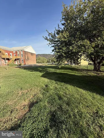 a view of a garden with a building in the background