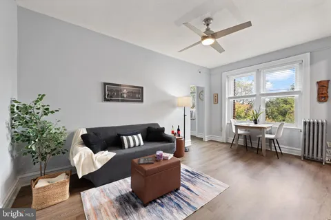 a living room with furniture and flowers