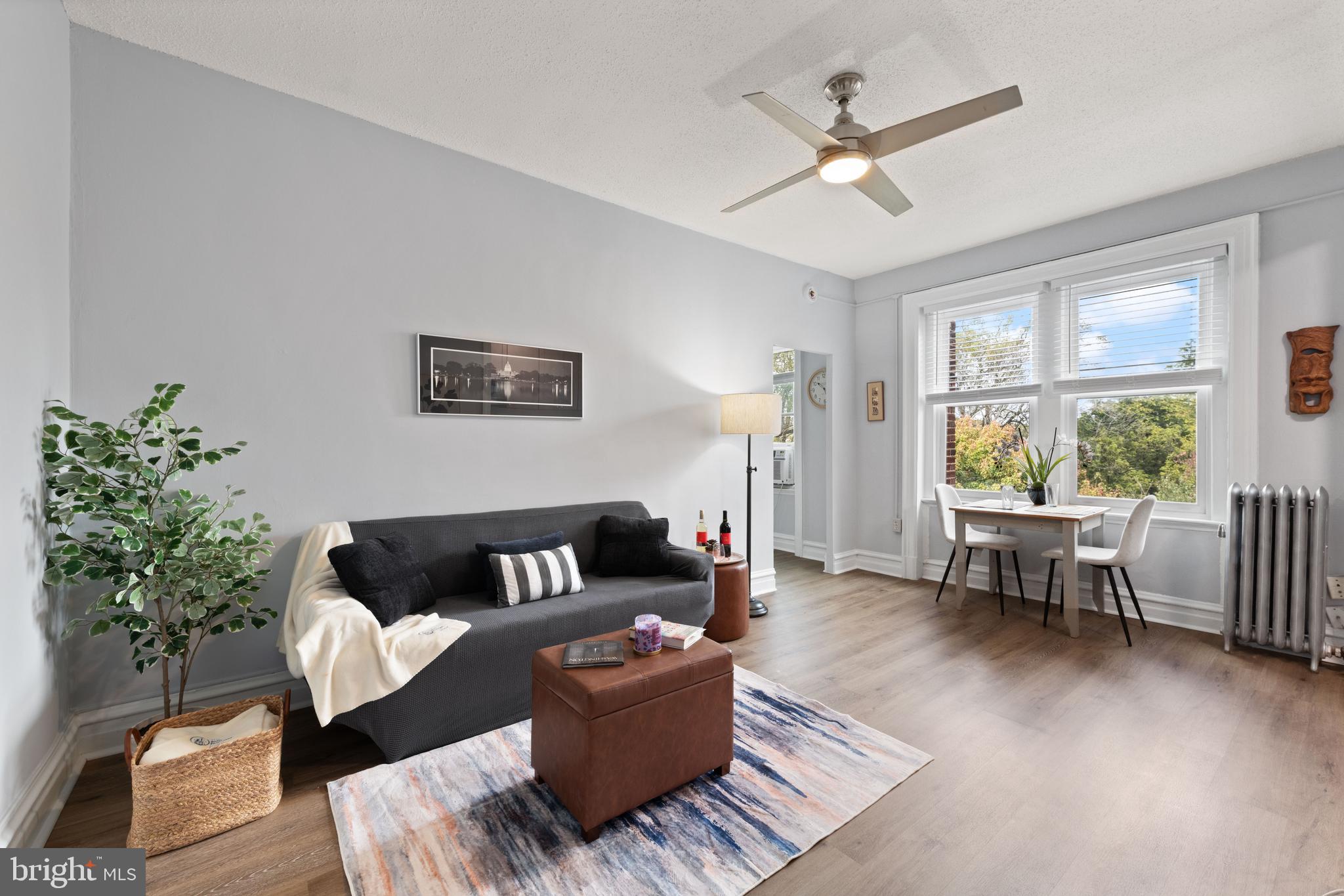 2456 20th Street Northwest, Unit 507 Washington, DC 20009 - Photo 13 of 42 a living room with furniture and a wooden floor