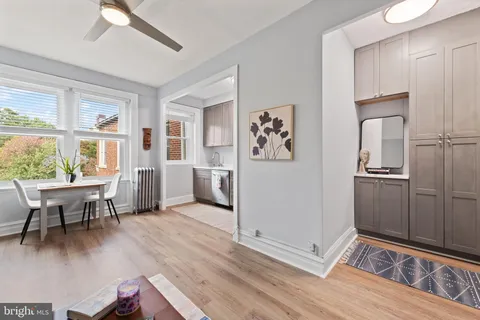 a kitchen with stainless steel appliances a stove a sink dishwasher a microwave oven with a dining table and chairs