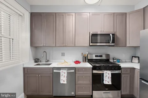a kitchen with a sink stove and cabinets