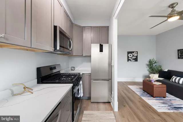 a living room with furniture and a kitchen