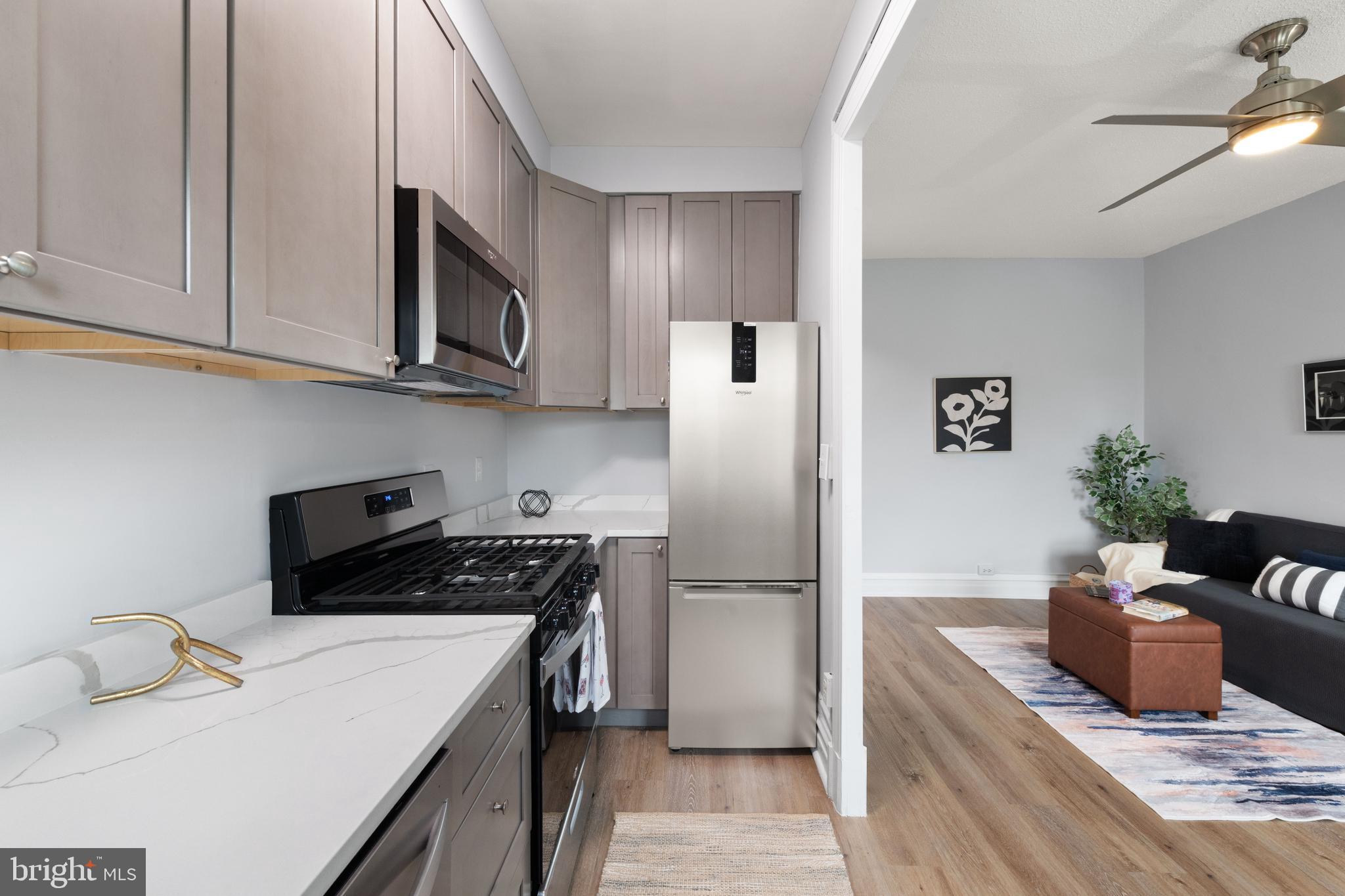 2456 20th Street Northwest, Unit 507 Washington, DC 20009 - Photo 26 of 42 a kitchen with stainless steel appliances granite countertop a refrigerator stove a sink and dishwasher