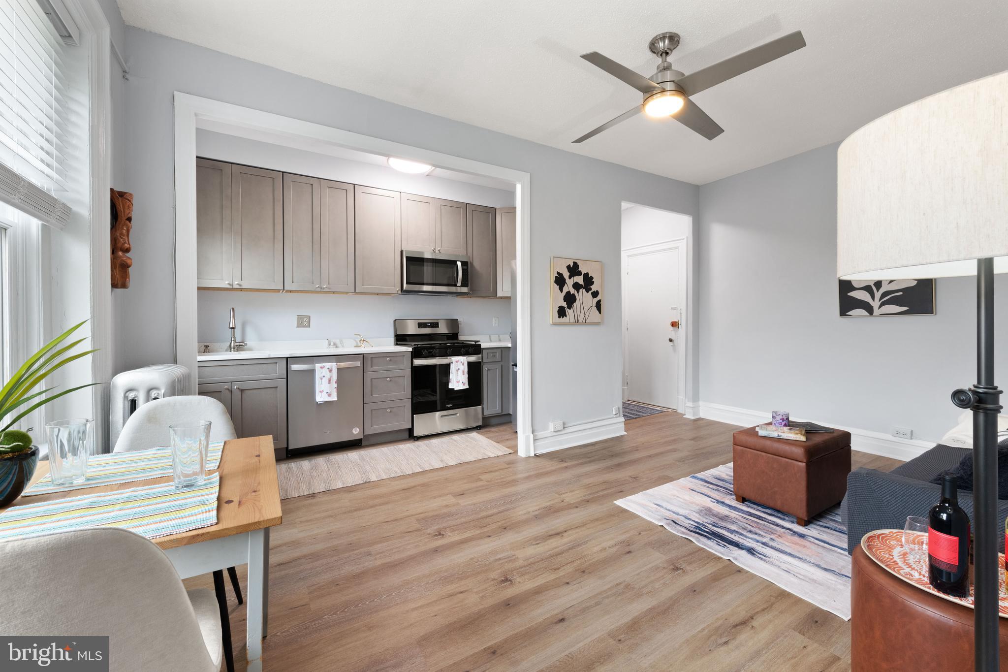 2456 20th Street Northwest, Unit 507 Washington, DC 20009 - Photo 27 of 42 a living room with furniture and a kitchen