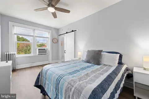 a bedroom with furniture and wooden floor