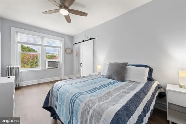 a bedroom with furniture and wooden floor