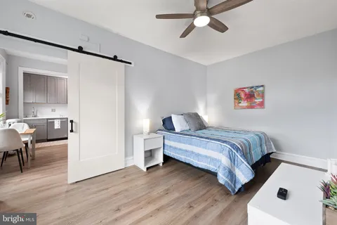 a bedroom with a bed and a chandelier