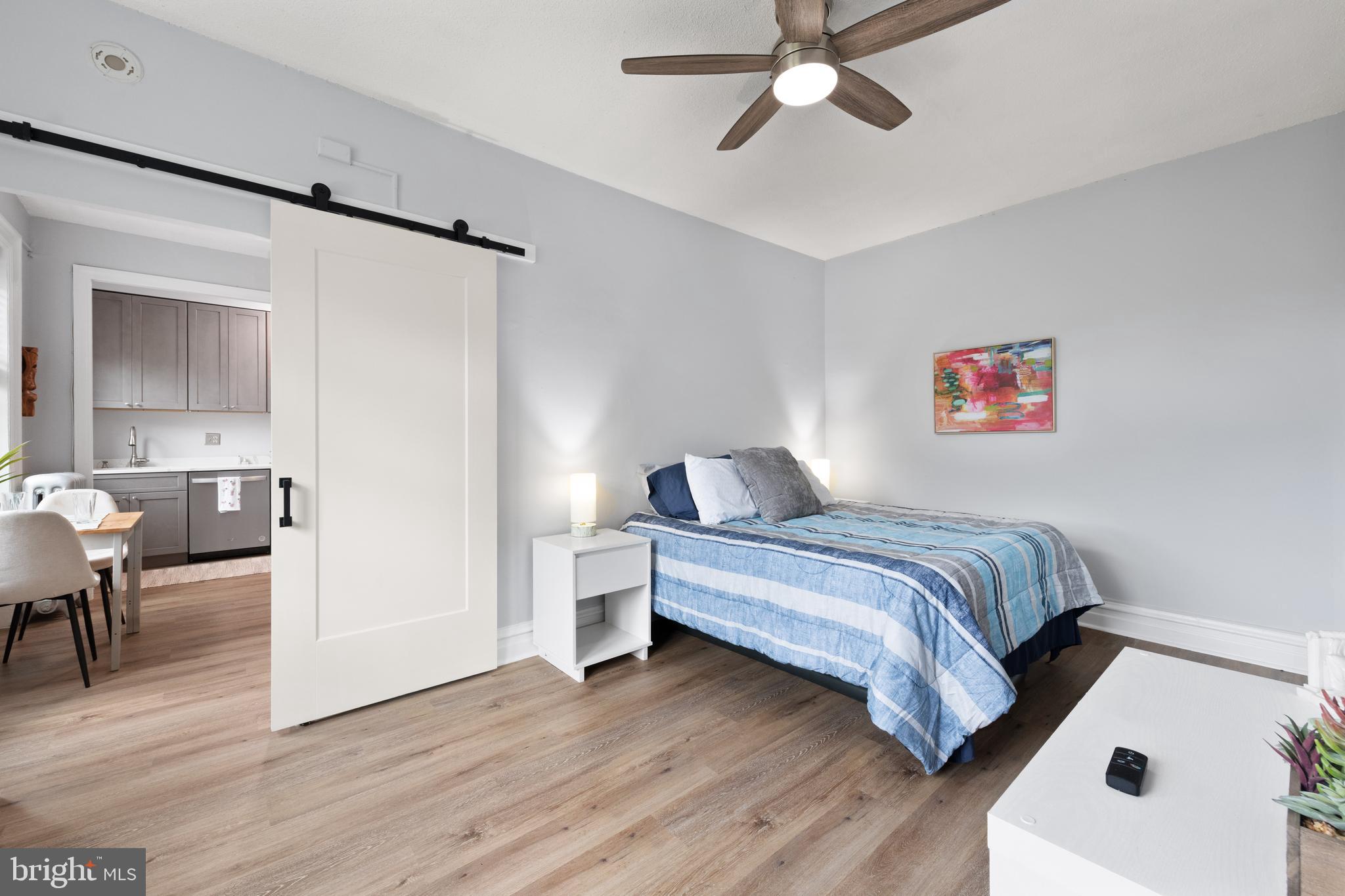 2456 20th Street Northwest, Unit 507 Washington, DC 20009 - Photo 30 of 42 a bedroom with a bed and a chair