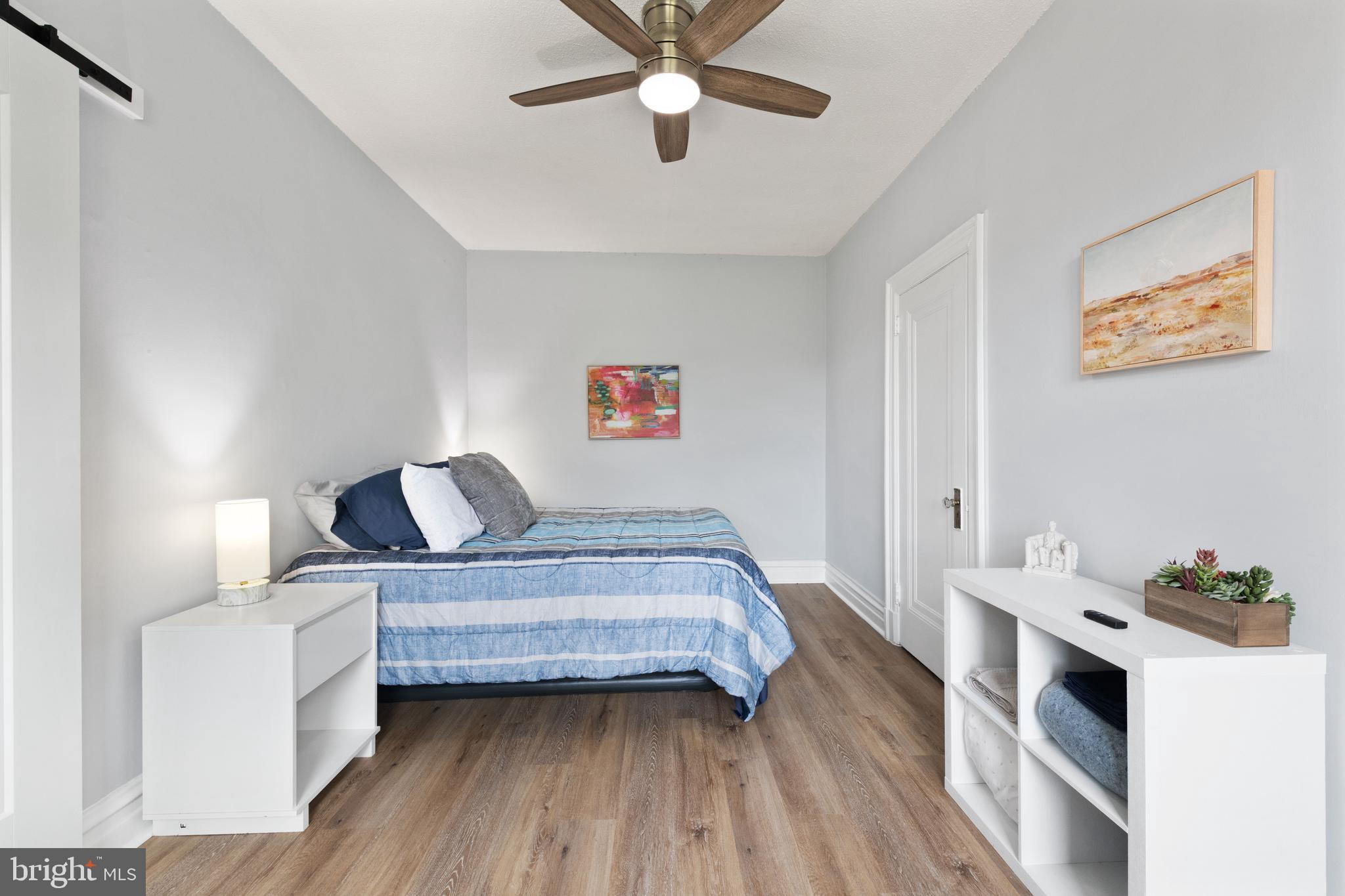 2456 20th Street Northwest, Unit 507 Washington, DC 20009 - Photo 31 of 42 a bedroom with a bed and a chandelier