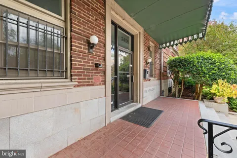 a view of a balcony with chair and potted plants