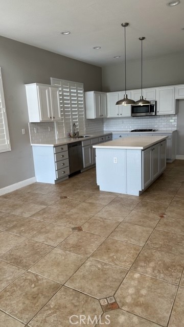 811 Inverlochy Drive Fallbrook, CA 92028 - Photo 14 of 31 a kitchen with stainless steel appliances a sink a counter top space cabinets and a window