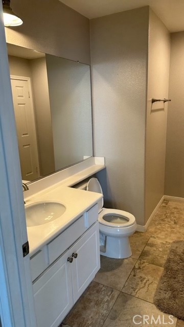 811 Inverlochy Drive Fallbrook, CA 92028 - Photo 18 of 31 a bathroom with a granite countertop toilet and a sink