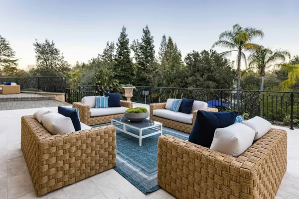 a view of a couches in the patio with a small yard