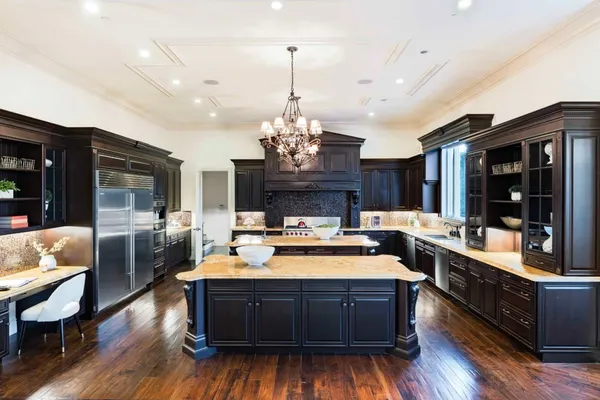a open kitchen with stainless steel appliances granite countertop a stove kitchen island and chandelier