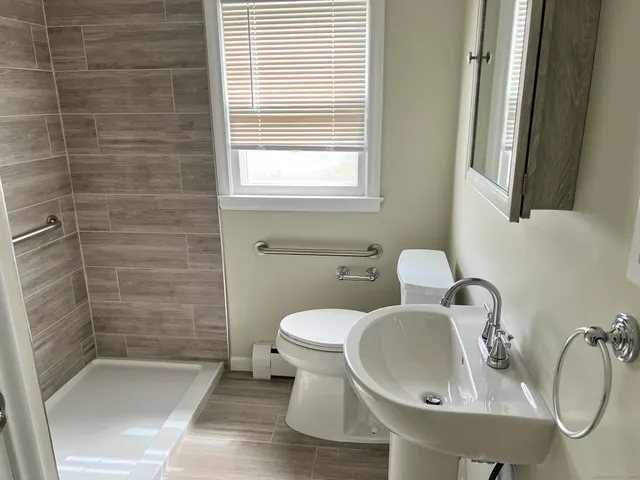 a bathroom with a sink a toilet and bathtub