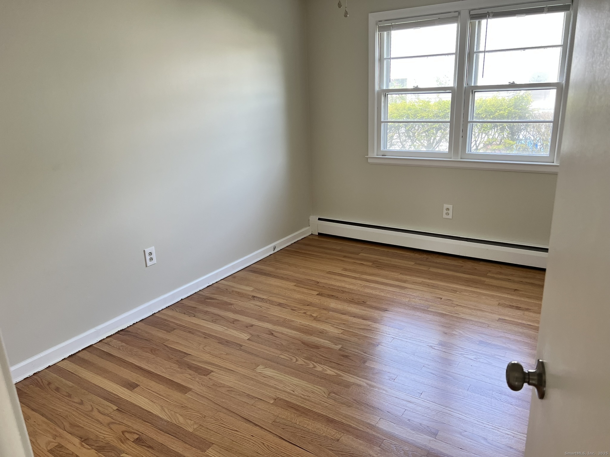 138 Carroll Street New Britain, CT 06053 - Photo 5 of 8 an empty room with wooden floor and windows