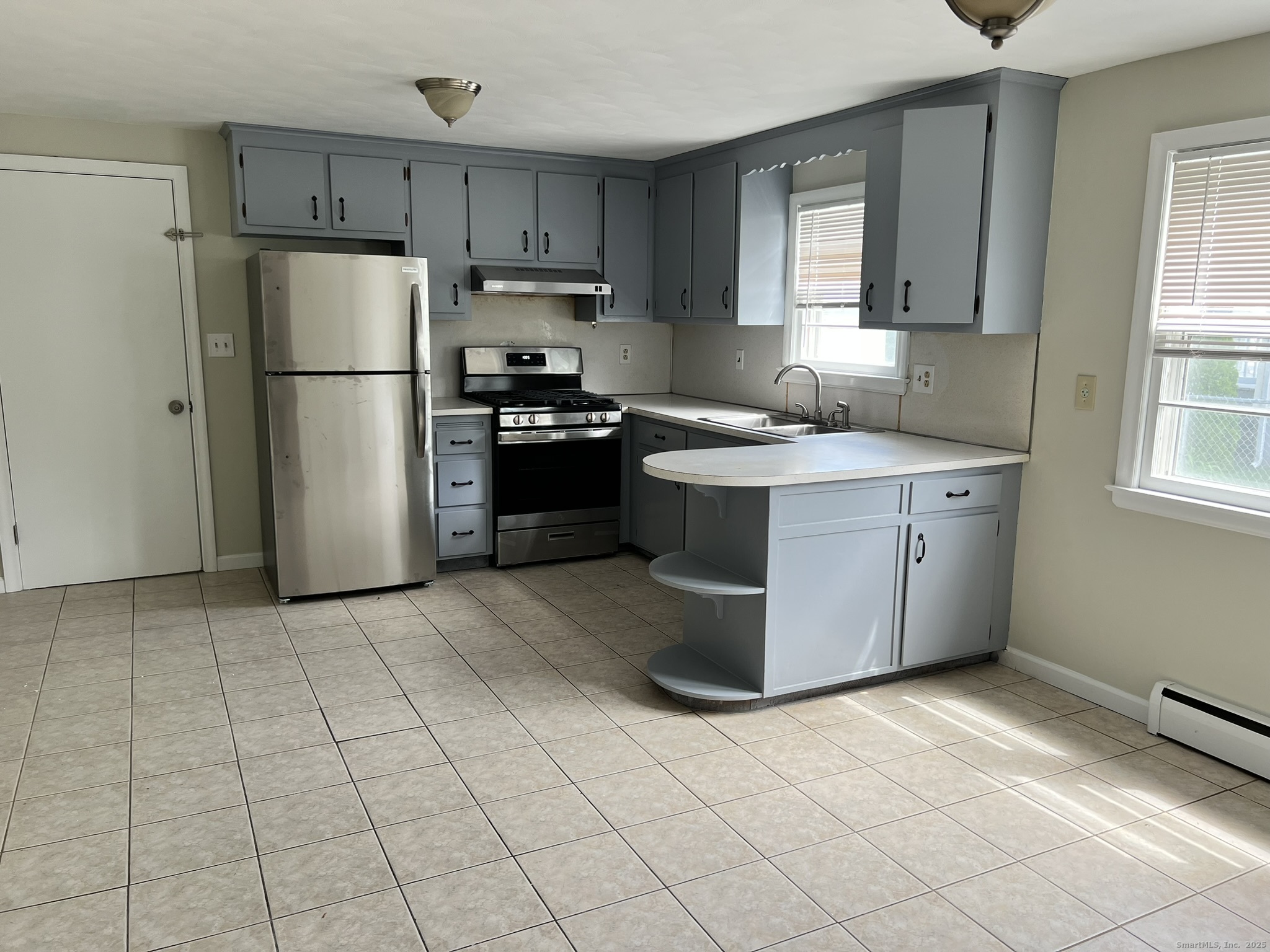 138 Carroll Street New Britain, CT 06053 - Photo 7 of 8 a kitchen with stainless steel appliances granite countertop a refrigerator stove top oven and sink