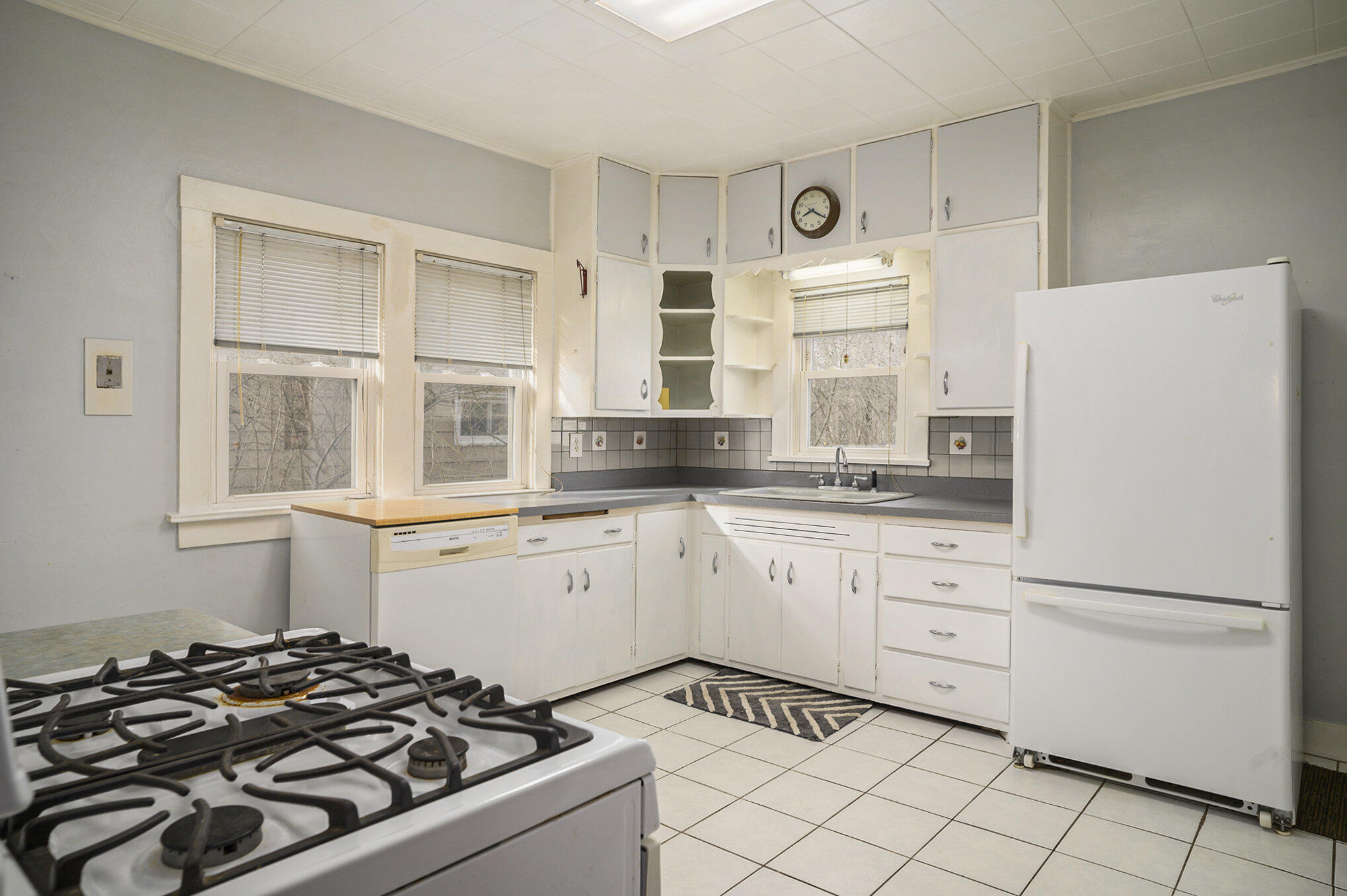 1013 Merrillville Road Crown Point, IN 46307 - Photo 7 of 16 a kitchen with white cabinets and appliances