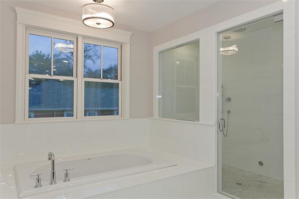 56 Broken Tree Road Newton, MA 02459 - Photo 18 of 30 a bathroom with a bathtub and a shower