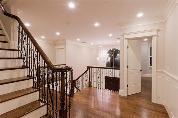 56 Broken Tree Road Newton, MA 02459 - Photo 29 of 30 a view of a hallway with wooden floor and staircase