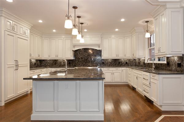56 Broken Tree Road Newton, MA 02459 - Photo 6 of 30 a kitchen with kitchen island granite countertop a stove a sink a center island and cabinets