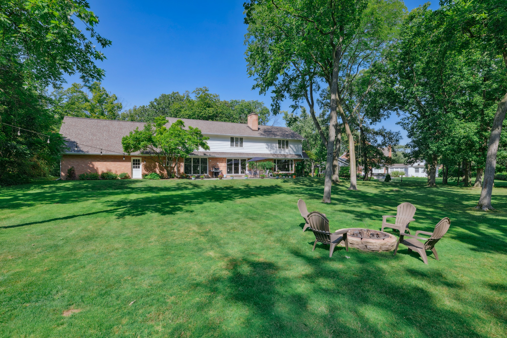 7 Old Hunt Road Northfield, IL 60093 - Photo 3 of 5 a view of a house with backyard sitting area and garden