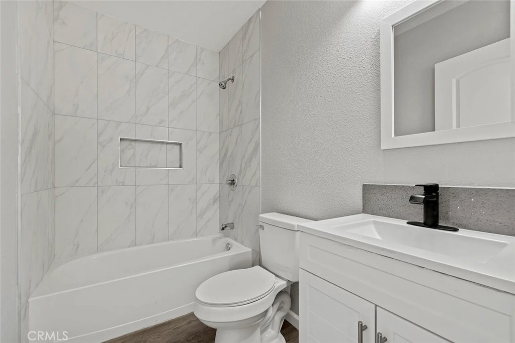 44532 Andale Avenue Lancaster, CA 93535 - Photo 13 of 21 a bathroom with a sink a toilet and a bathtub