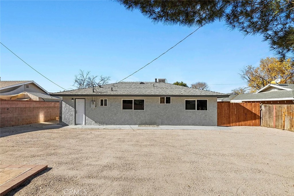 44532 Andale Avenue Lancaster, CA 93535 - Photo 18 of 21 a house with trees in front of it