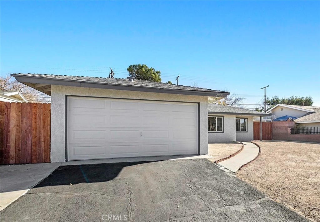 44532 Andale Avenue Lancaster, CA 93535 - Photo 3 of 21 a front view of a house with a yard