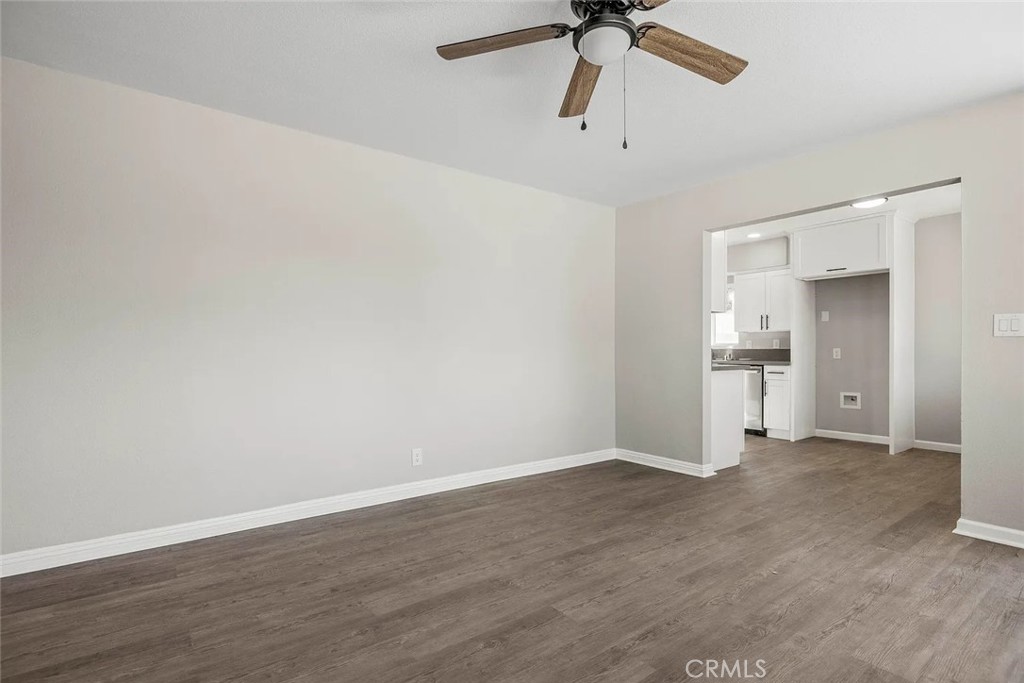 44532 Andale Avenue Lancaster, CA 93535 - Photo 9 of 21 wooden floor in an empty room with a chandelier fan