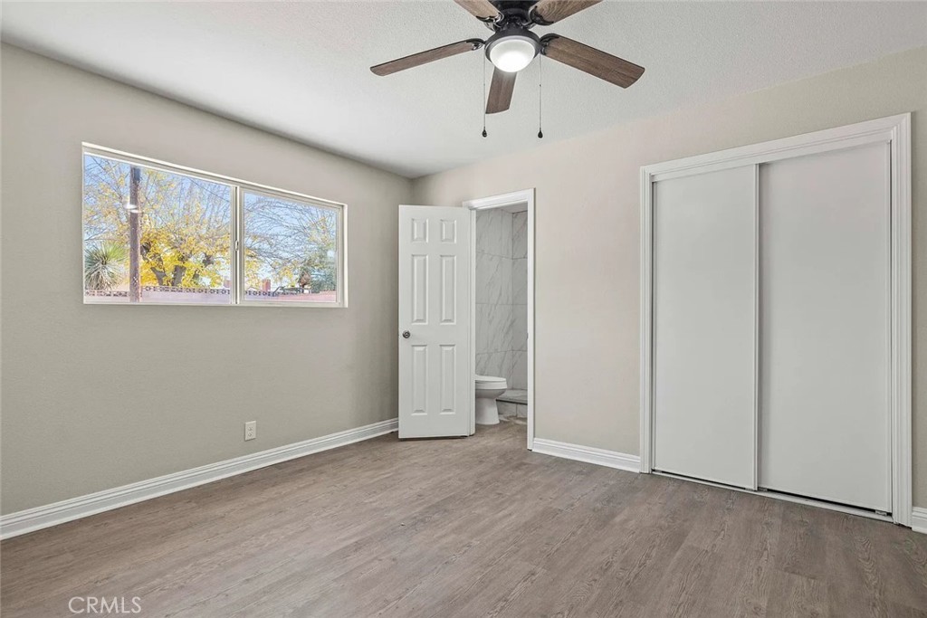 44532 Andale Avenue Lancaster, CA 93535 - Photo 10 of 21 a view of an empty room with window and wooden floor