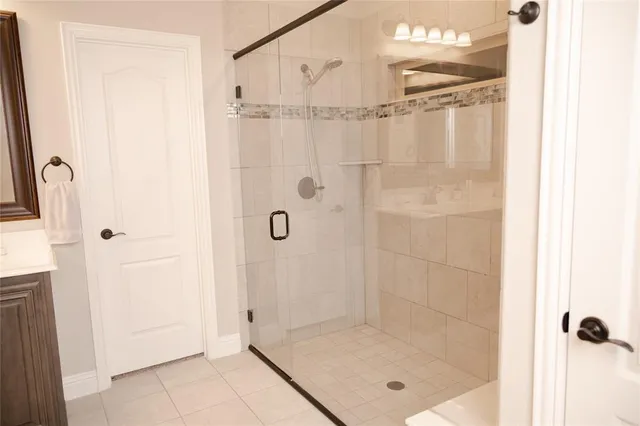 a bathroom with a glass shower door
