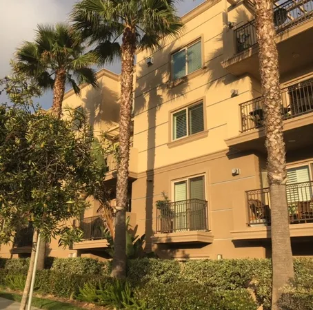 a front view of a building with a tree