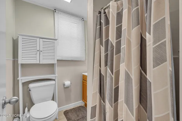 a white toilet sitting next to a bathroom sink
