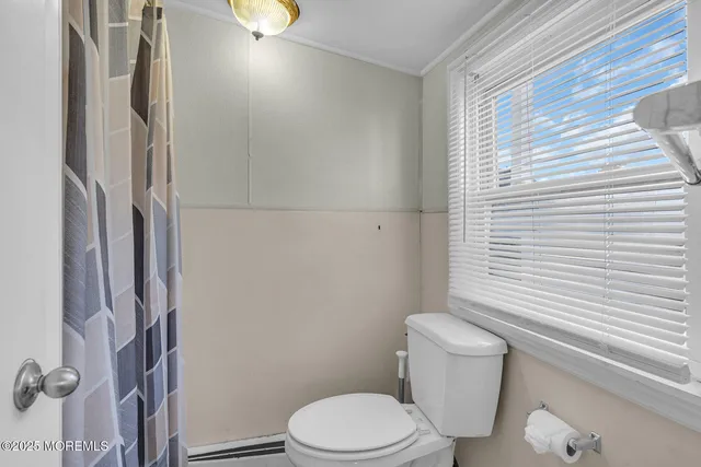 a white toilet sitting next to a bathroom sink