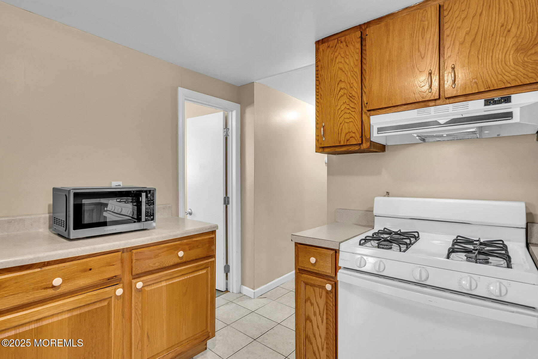 549 Brielle Road Manasquan, NJ 08736 - Photo 10 of 17 a kitchen with a stove and a microwave