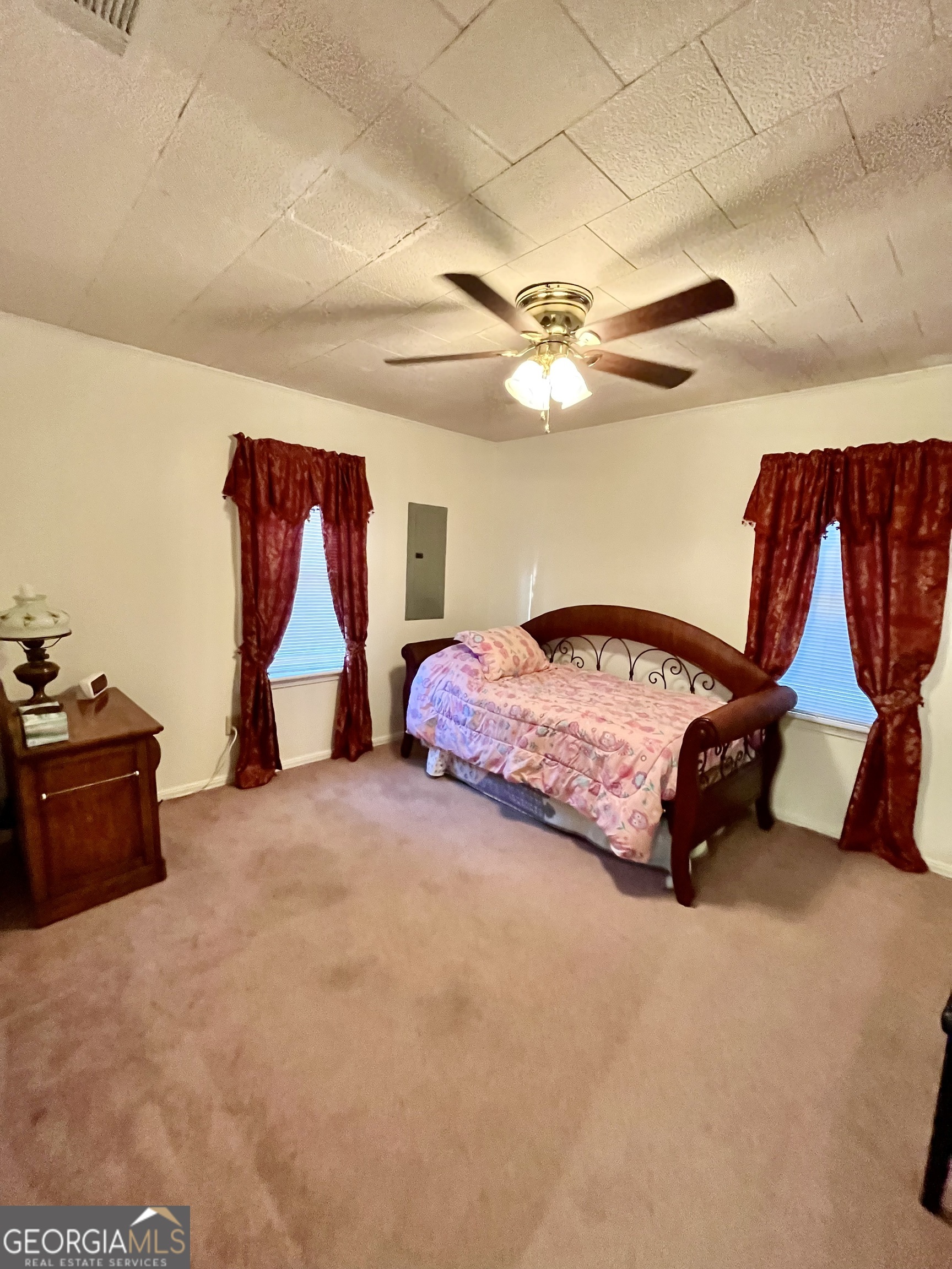 404 Community Drive Waycross, GA 31501 - Photo 12 of 24 a bedroom with a bed and a chandelier