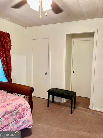 a bedroom with a bed and window