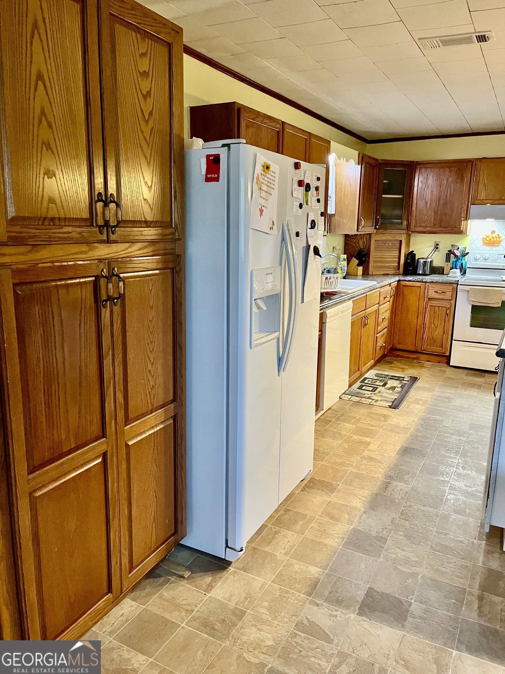 404 Community Drive Waycross, GA 31501 - Photo 20 of 24 a kitchen with stainless steel appliances granite countertop a refrigerator a stove and a sink