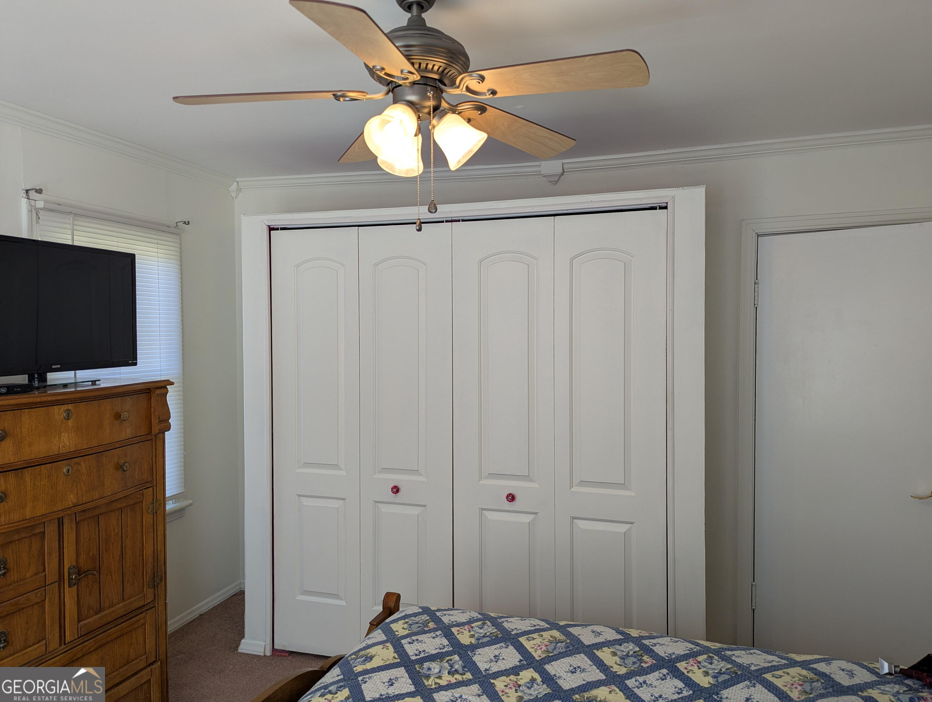 404 Community Drive Waycross, GA 31501 - Photo 23 of 24 a bedroom with a bed and a chandelier