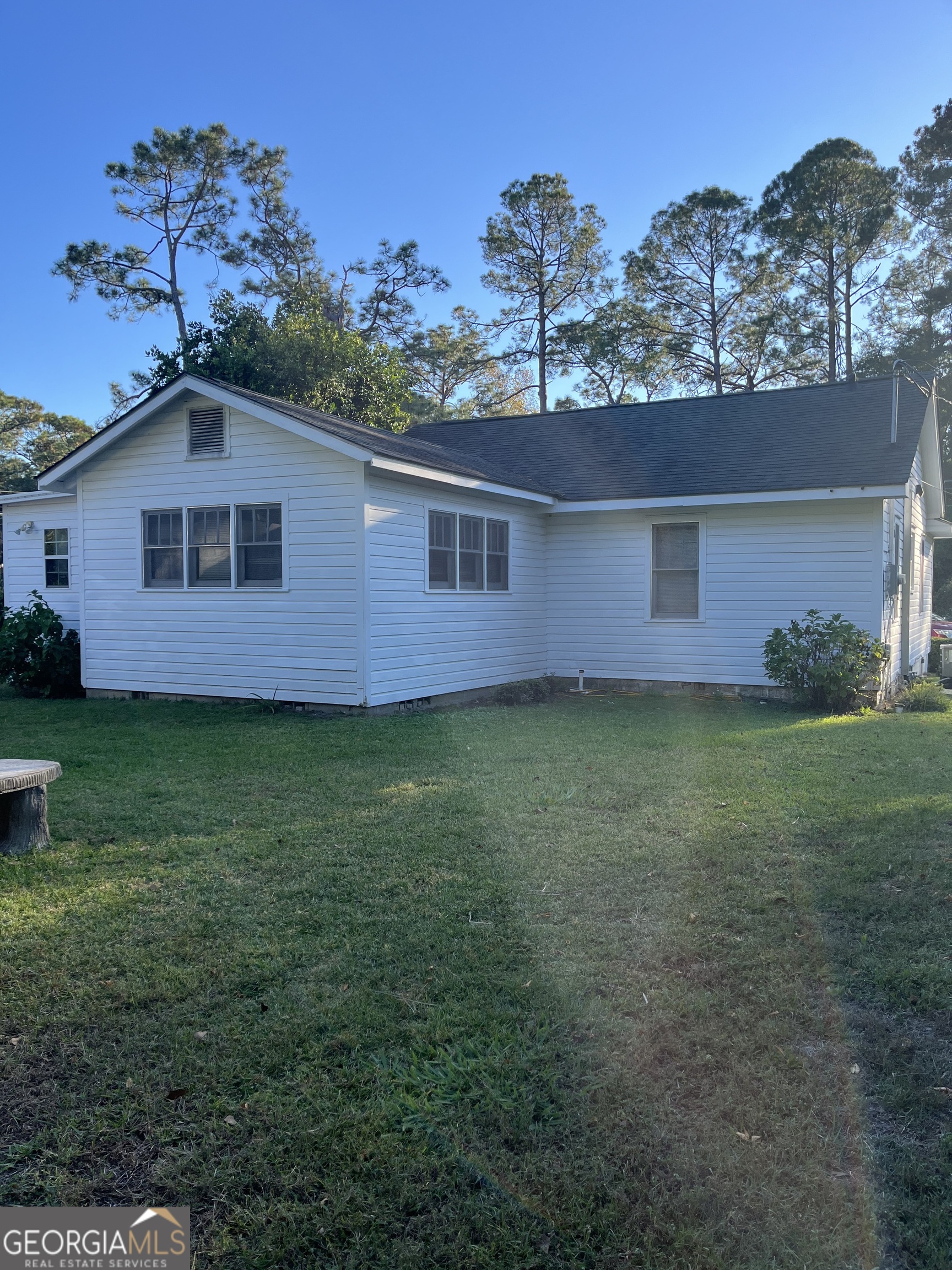 404 Community Drive Waycross, GA 31501 - Photo 4 of 24 a front view of a house with a garden