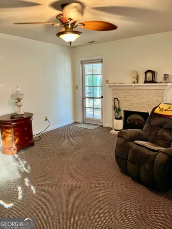 a living room with furniture a fireplace and a window