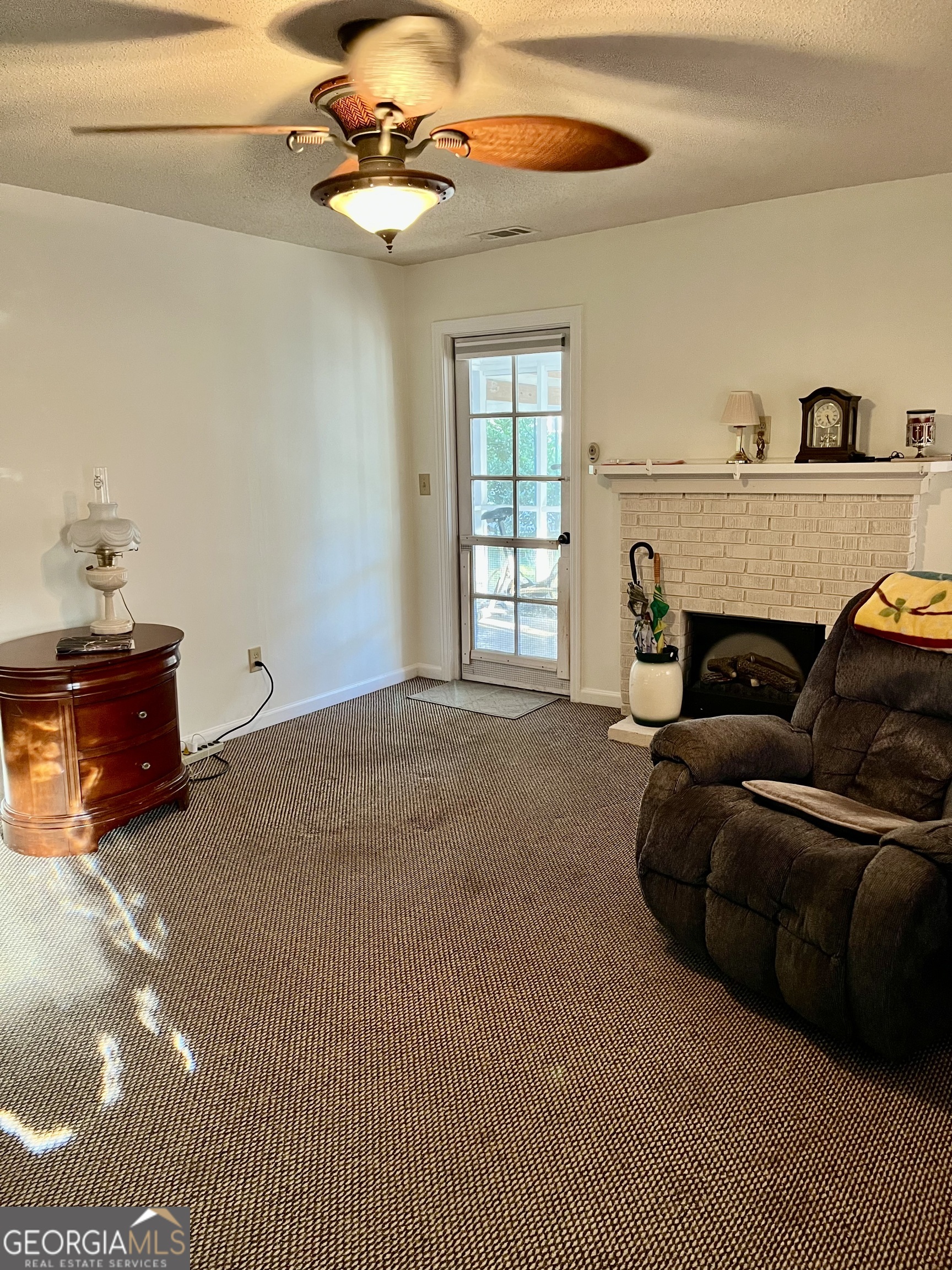 404 Community Drive Waycross, GA 31501 - Photo 6 of 24 a living room with furniture a fireplace and a window