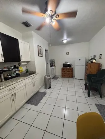 a kitchen with stainless steel appliances kitchen island granite countertop a sink and cabinets
