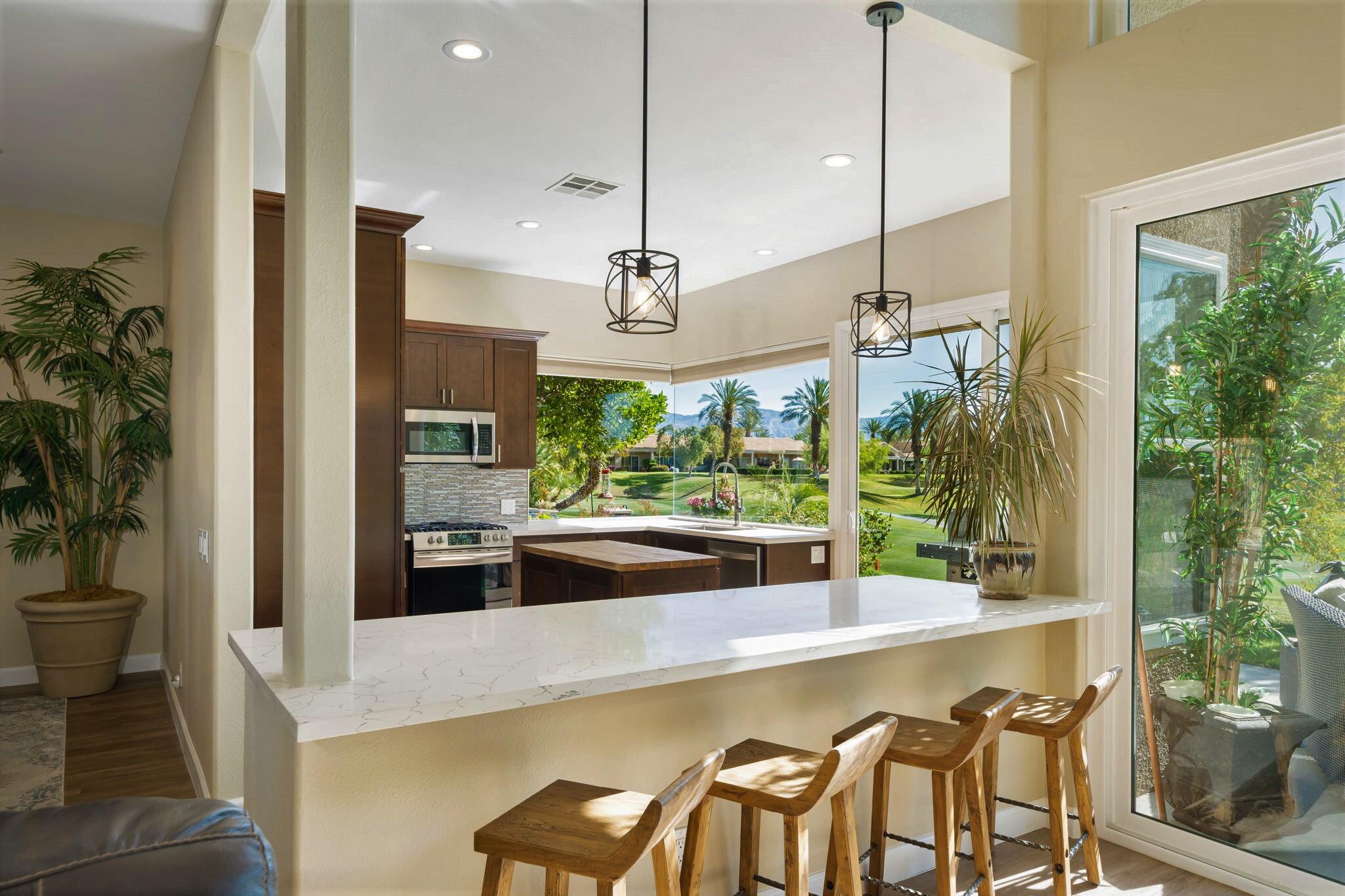 33 Colonial Drive Rancho Mirage, CA 92270 - Photo 21 of 62 a large kitchen with a large window and stainless steel appliances
